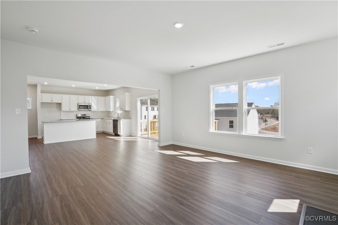 229 Bellevue Circle Aylett, VA 23009 - Photo 5 of 18 a view of a livingroom with wooden floor kitchen view and a window
