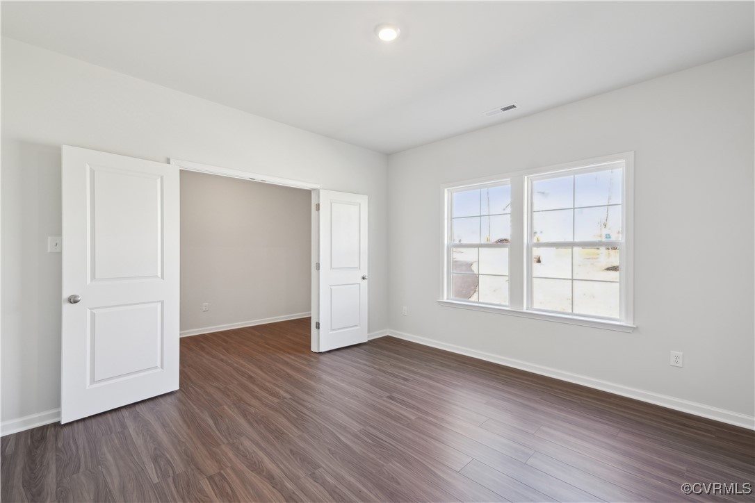 229 Bellevue Circle Aylett, VA 23009 - Photo 7 of 18 an empty room with wooden floor and windows