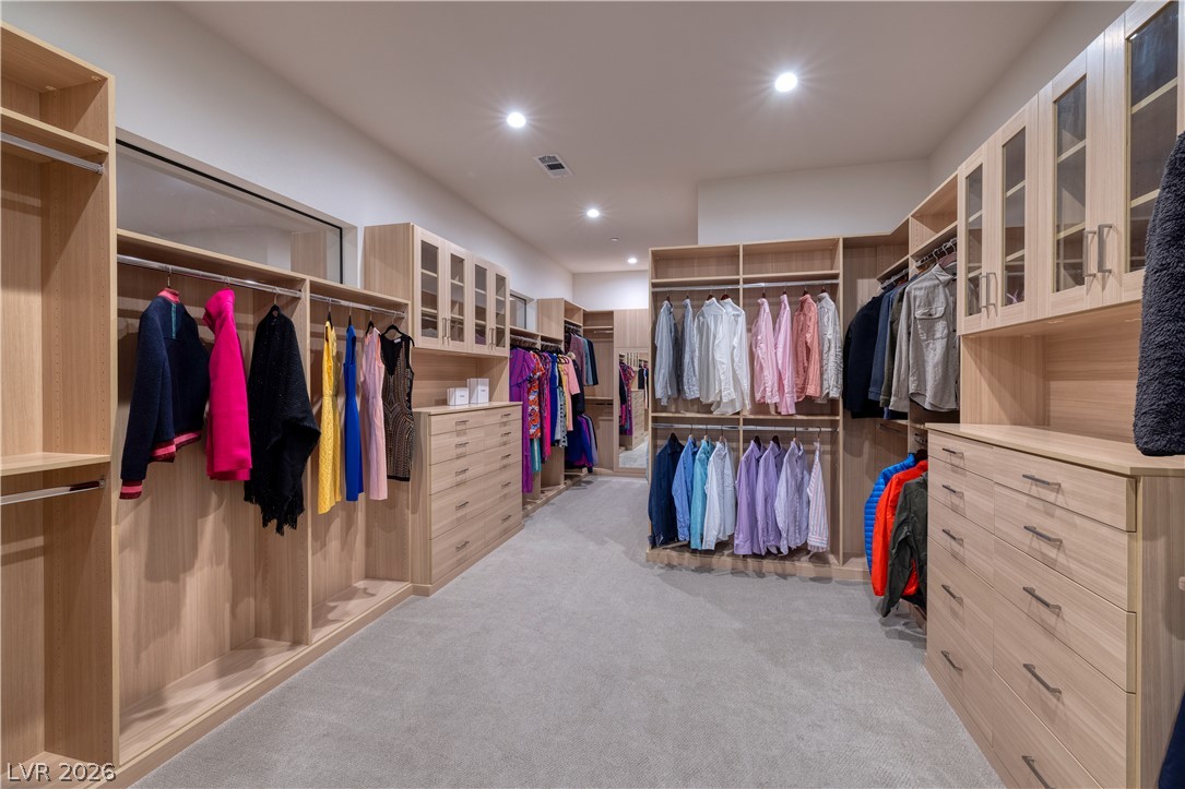 25 Falling Ridge Lane Henderson, NV 89011 - Photo 20 of 48 An organized closet with built-in wooden shelving and drawers for ample storage.