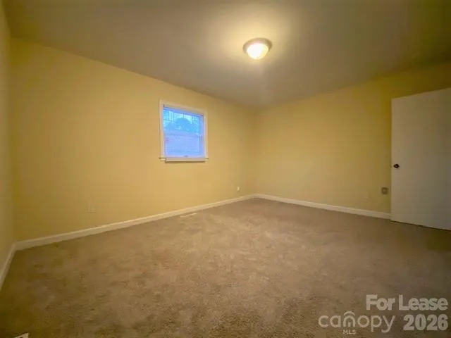 an empty room with a empty space and a window