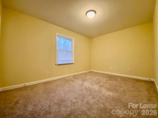 an empty room with a empty space and a window