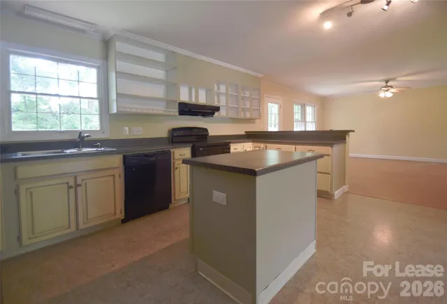 a kitchen with stainless steel appliances granite countertop a sink stove and window