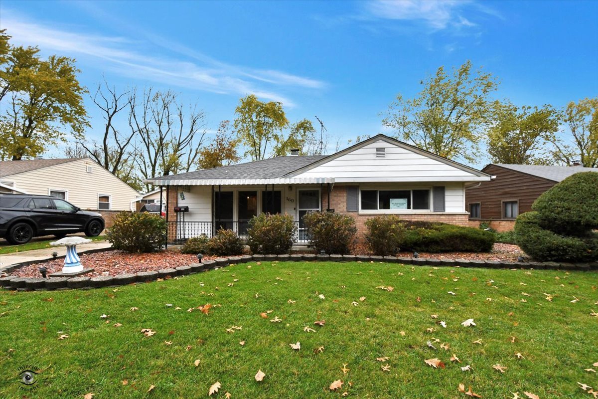 160 Monee Road Park Forest, IL 60466 - Photo 2 of 24 a front view of a house with a garden and patio