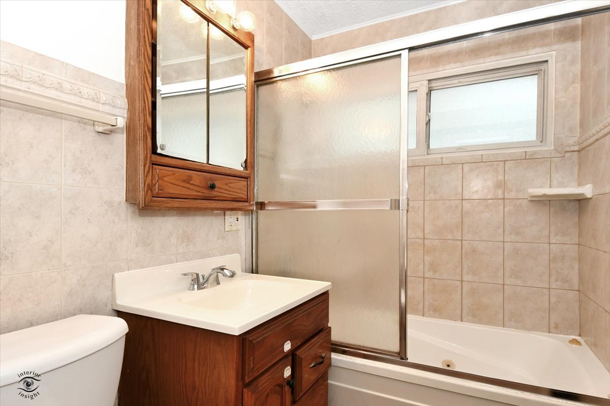 160 Monee Road Park Forest, IL 60466 - Photo 12 of 24 a bathroom with a sink toilet and shower