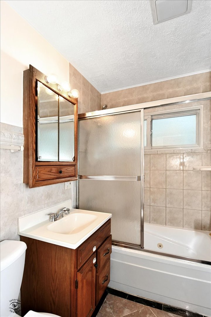 160 Monee Road Park Forest, IL 60466 - Photo 13 of 24 a bathroom with a sink and a mirror