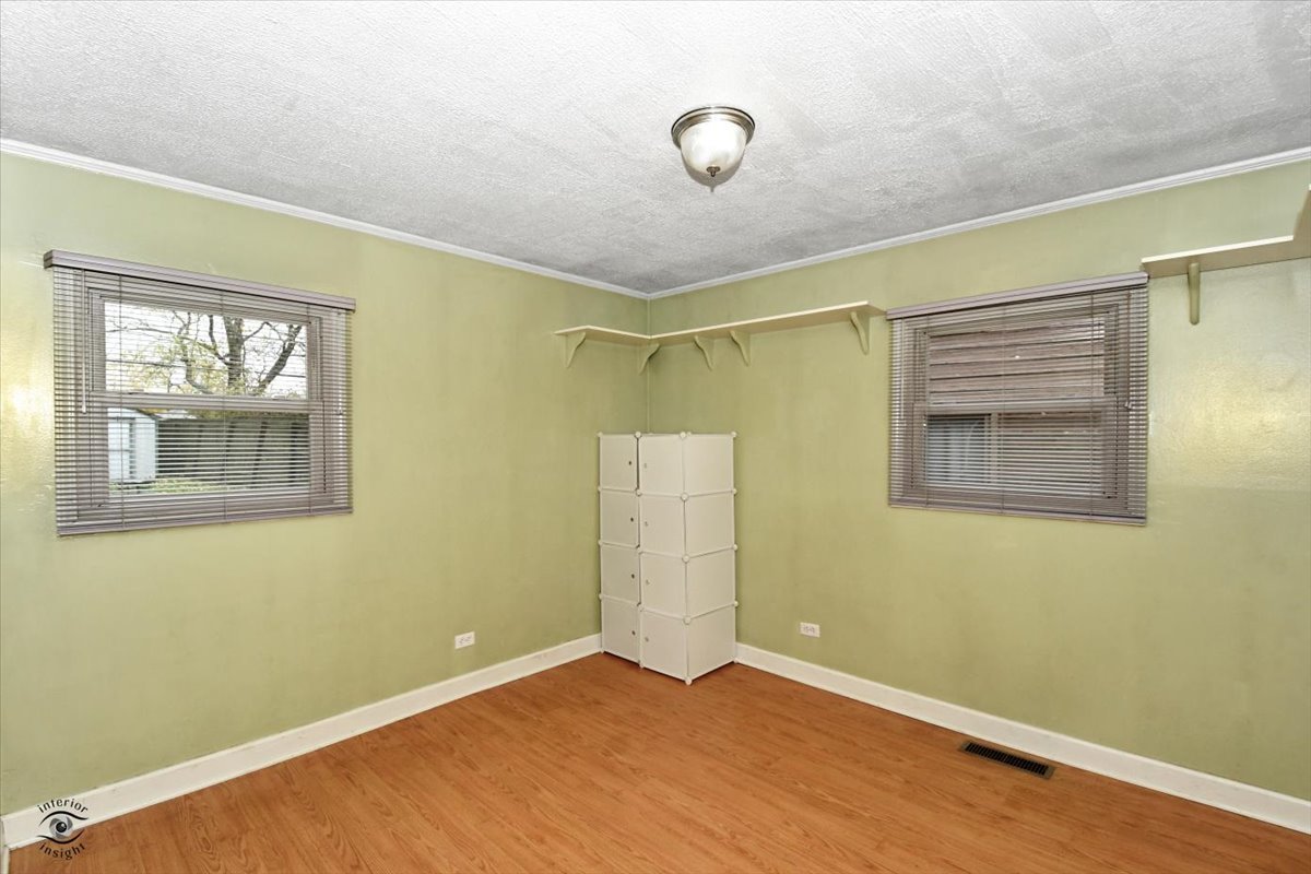 160 Monee Road Park Forest, IL 60466 - Photo 14 of 24 a view of an empty room with wooden floor and a window