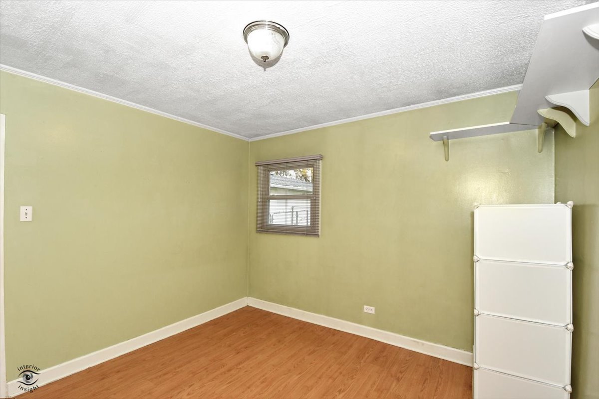 160 Monee Road Park Forest, IL 60466 - Photo 15 of 24 a view of a room with a refrigerator and wooden floor