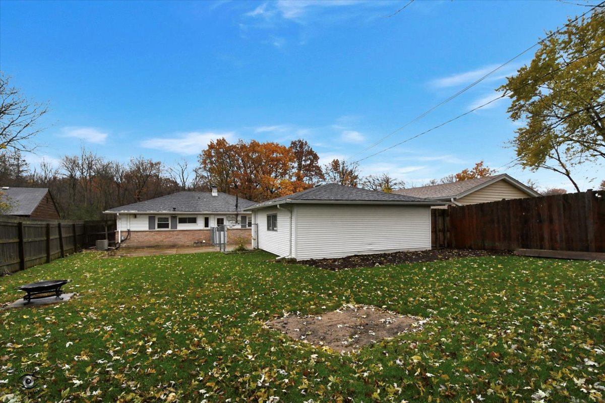 160 Monee Road Park Forest, IL 60466 - Photo 21 of 24 a view of a house with a big yard and large tree