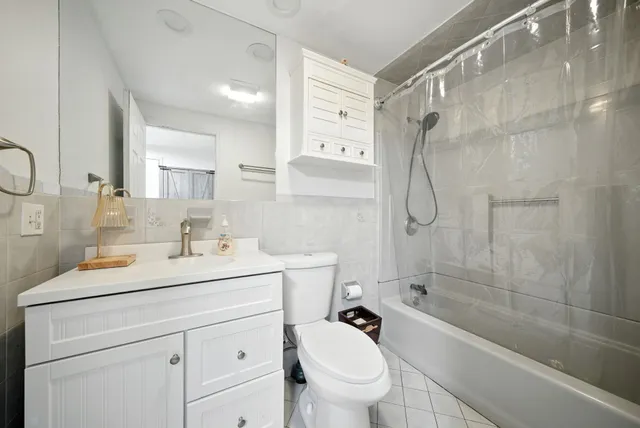 a bathroom with a sink toilet tub and shower