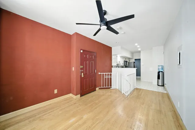 a view of a kitchen with a sink and wooden floor