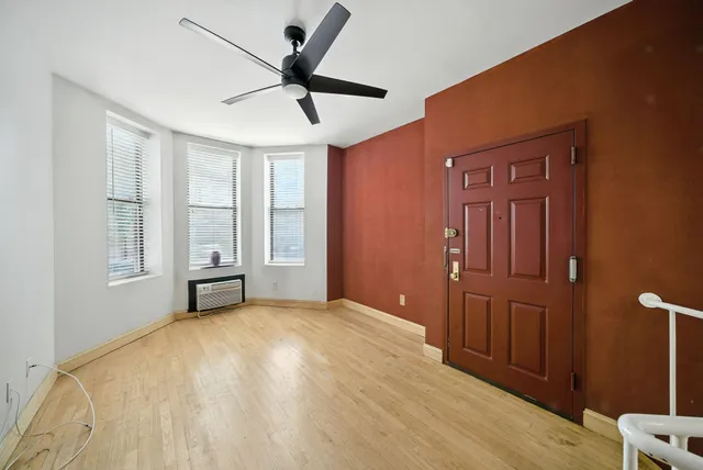 a big room with closet and windows