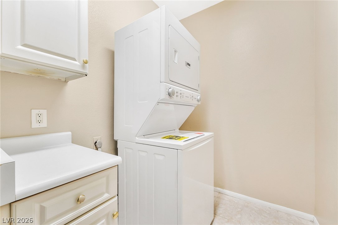 2050 West Warm Springs Road, Unit 2411 Henderson, NV 89014 - Photo 30 of 37 A dedicated laundry area features convenient stacked appliances and practical cabinetry.