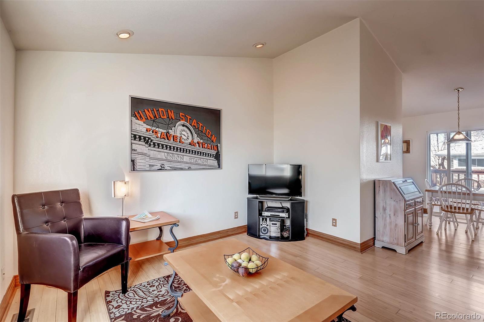 965 Wolff Street, Unit A Denver, CO 80204 - Photo 1 of 34 a living room with furniture a piano and a flat screen tv