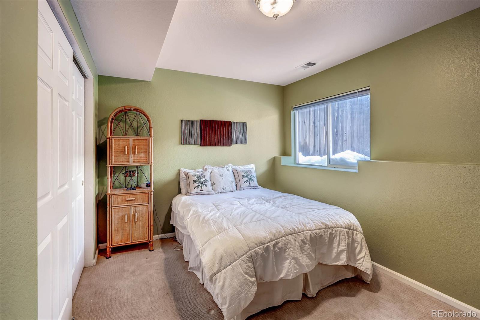 965 Wolff Street, Unit A Denver, CO 80204 - Photo 14 of 34 a bedroom with a bed and a painting on the wall
