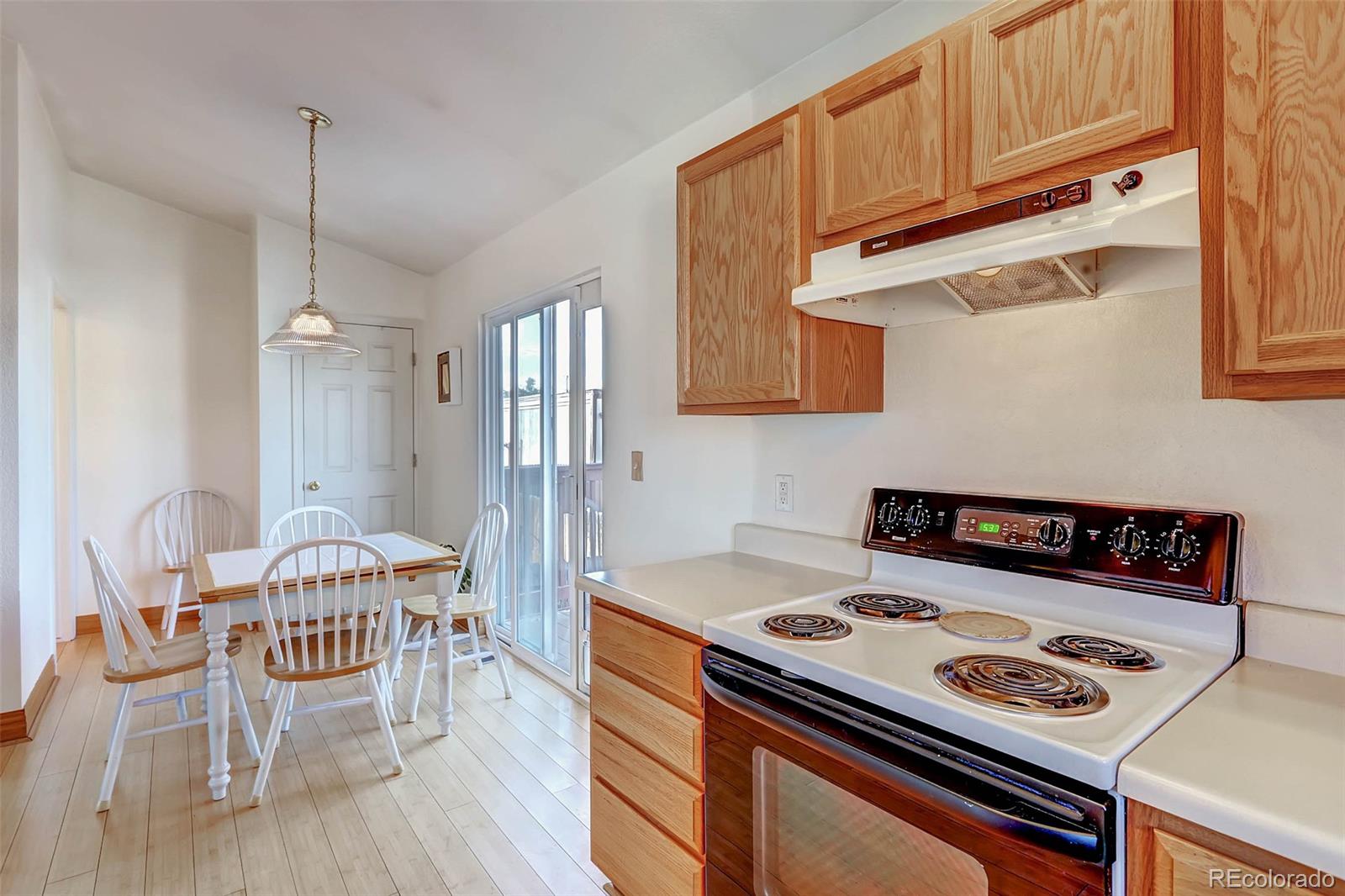 965 Wolff Street, Unit A Denver, CO 80204 - Photo 17 of 34 a kitchen with a stove a refrigerator and wooden floor