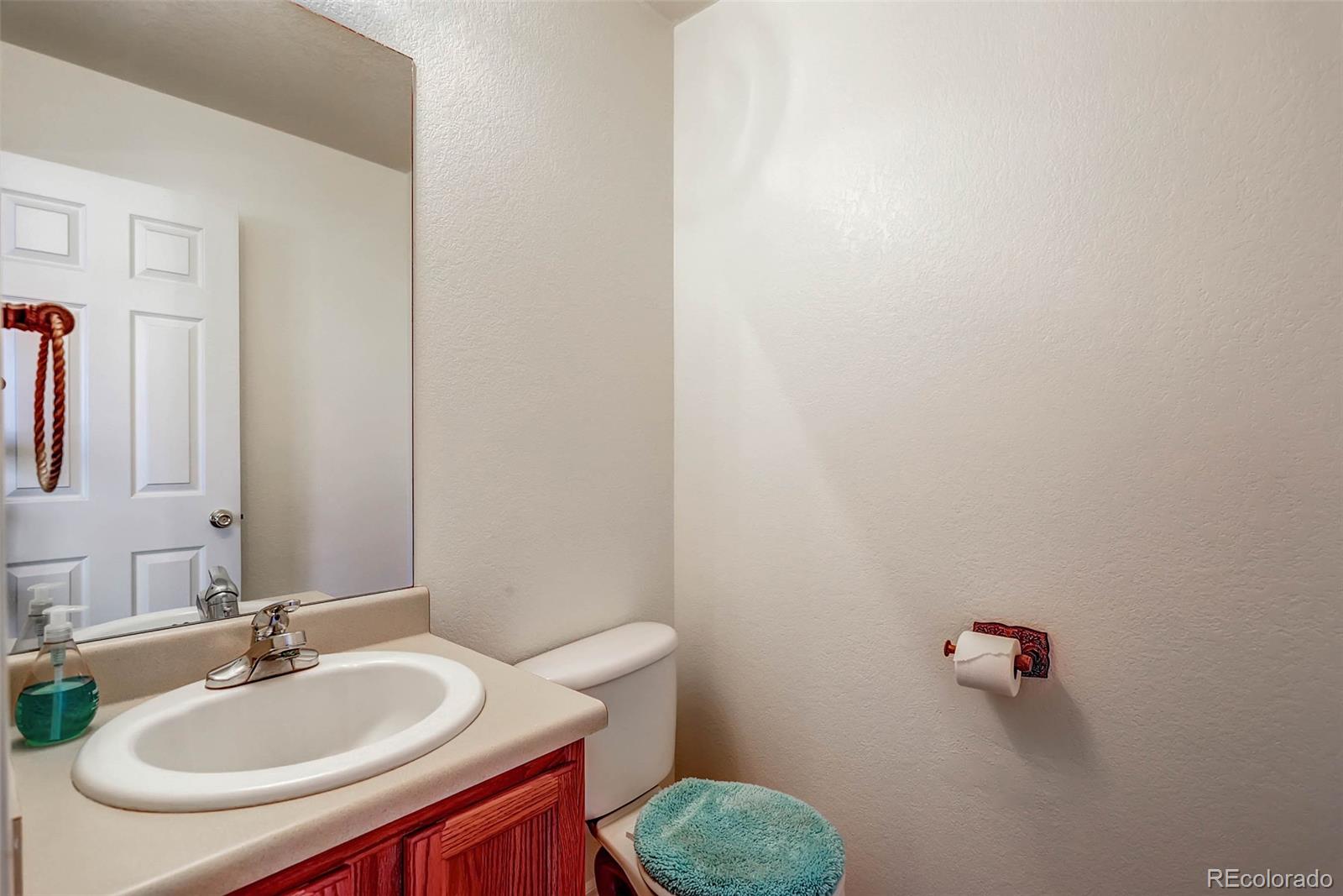965 Wolff Street, Unit A Denver, CO 80204 - Photo 19 of 34 a bathroom with a sink and a mirror
