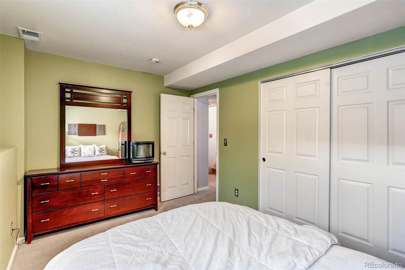 965 Wolff Street, Unit A Denver, CO 80204 - Photo 22 of 34 a bedroom with a bed and a dresser