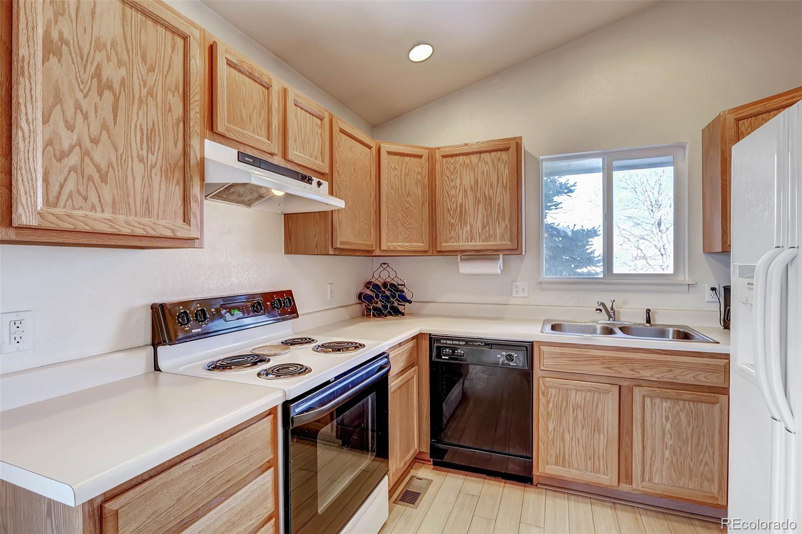 965 Wolff Street, Unit A Denver, CO 80204 - Photo 3 of 34 a kitchen with stainless steel appliances a sink a stove a refrigerator cabinets and a window