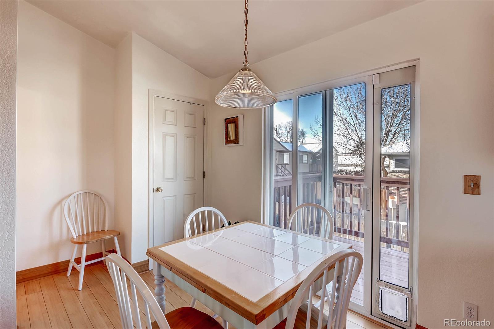 965 Wolff Street, Unit A Denver, CO 80204 - Photo 4 of 34 a dining room with furniture a chandelier and wooden floor