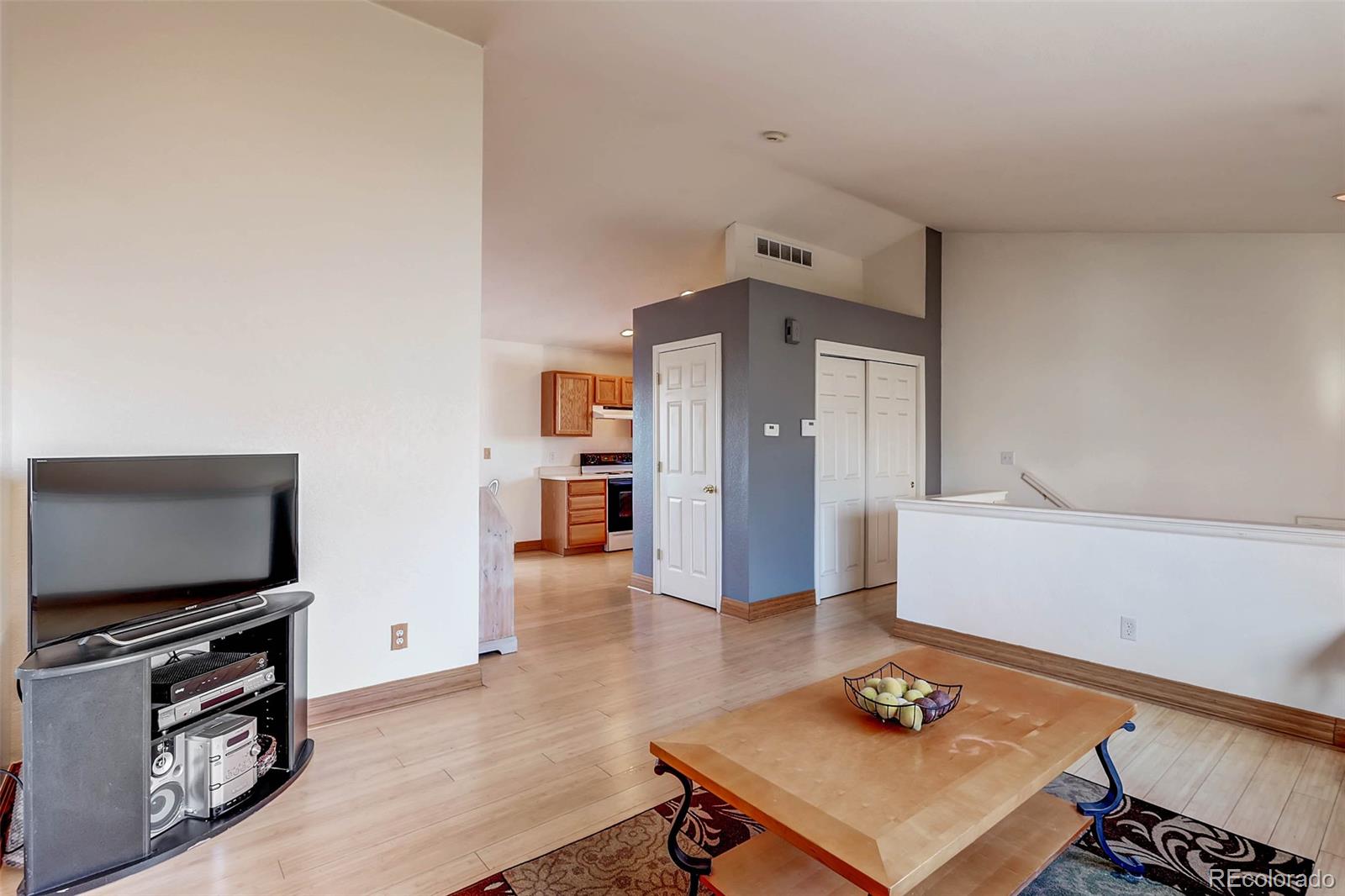 965 Wolff Street, Unit A Denver, CO 80204 - Photo 6 of 34 a living room with furniture and a flat screen tv