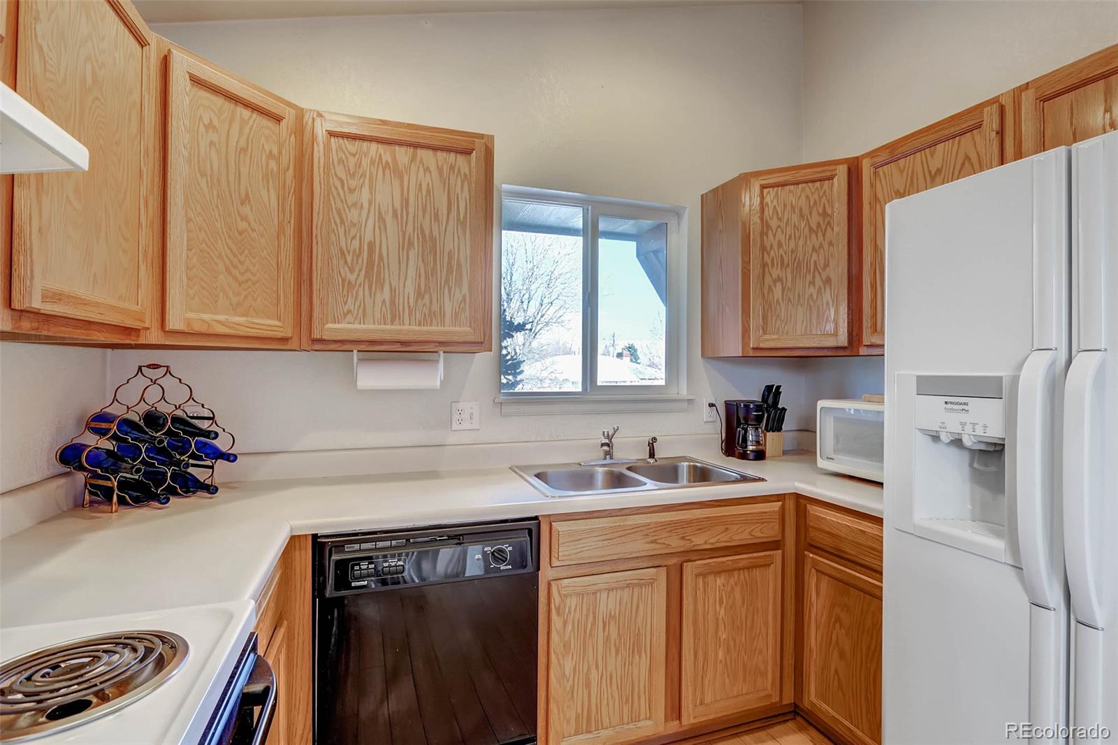 965 Wolff Street, Unit A Denver, CO 80204 - Photo 9 of 34 a kitchen with stainless steel appliances granite countertop a sink a refrigerator and cabinets