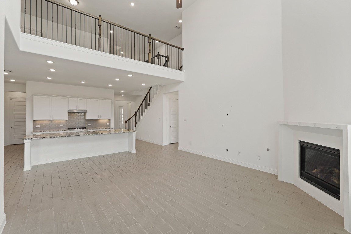 8010 Chantilly Manor Fulshear, TX 77441 - Photo 16 of 50 Discover the open-concept kitchen with a spacious granite island, ideal for casual dining and entertaining. Perfect for setting up barstools for cozy breakfasts or evening chats.