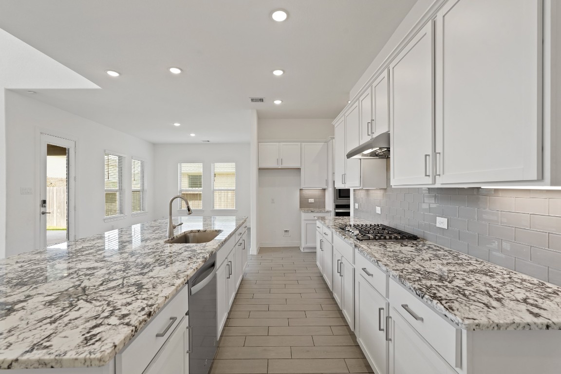 8010 Chantilly Manor Fulshear, TX 77441 - Photo 18 of 50 Second view of the kitchen showcasing sleek stainless steel appliances, recessed lighting, and a modern, open layout that blends style and functionality