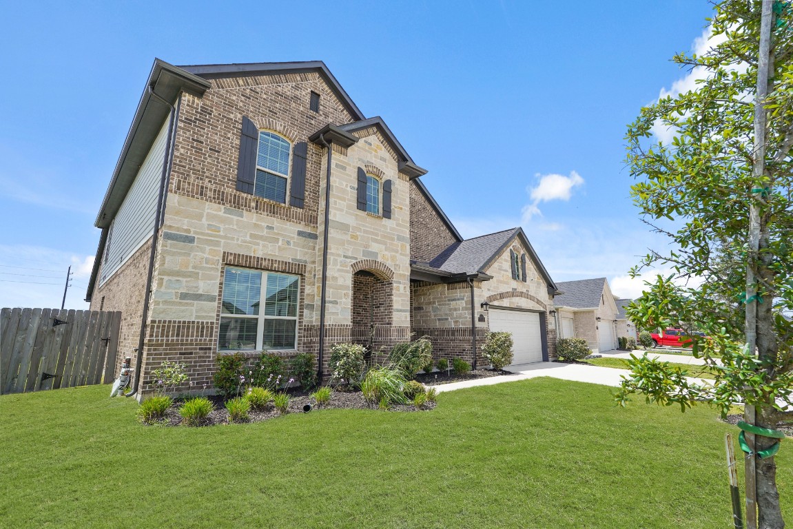 8010 Chantilly Manor Fulshear, TX 77441 - Photo 2 of 50 Four-sided brick exterior on the first floor with a beautiful brick and stone combination. Features a well-maintained lawn!