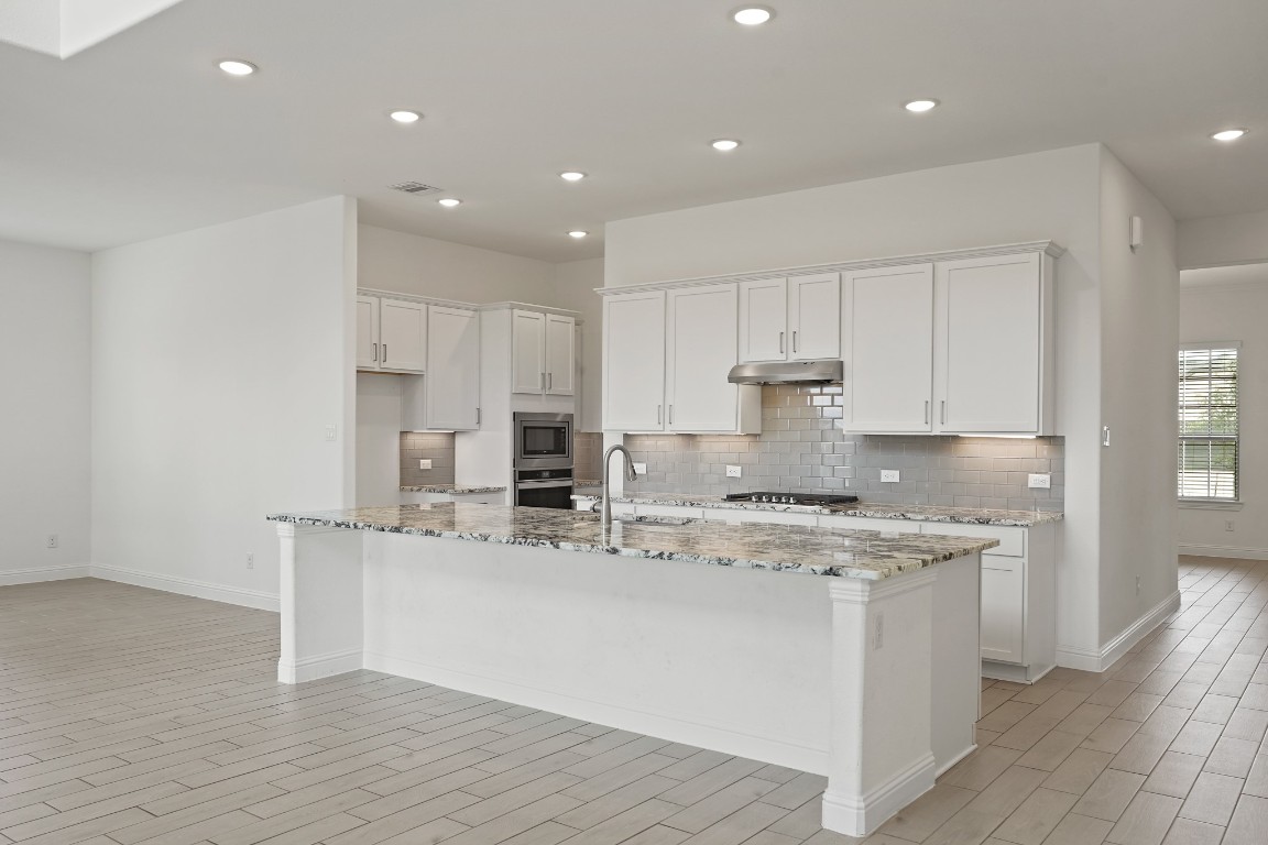 8010 Chantilly Manor Fulshear, TX 77441 - Photo 22 of 50 Forth view of the kitchen showcasing sleek stainless steel appliances, recessed lighting, and a modern, open layout that blends style and functionality