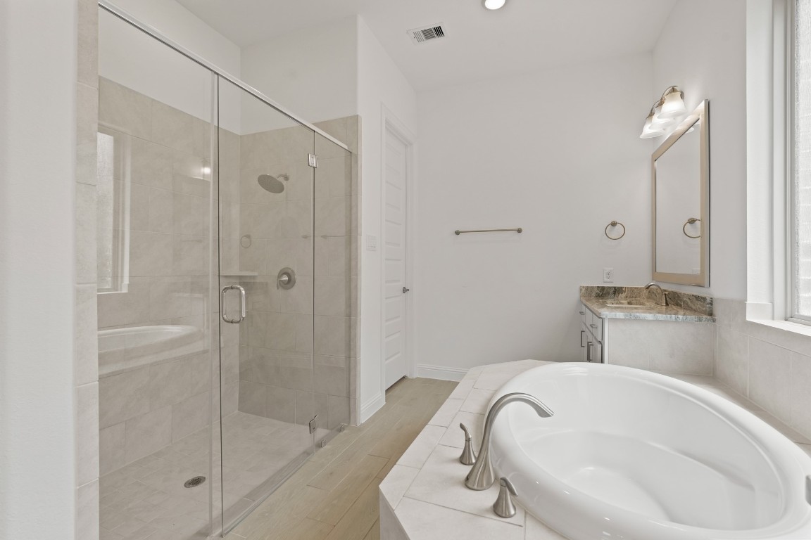 8010 Chantilly Manor Fulshear, TX 77441 - Photo 31 of 50 The primary bathroom features a jetted tub, a stand-up shower, and a dual vanity for added convenience and luxury