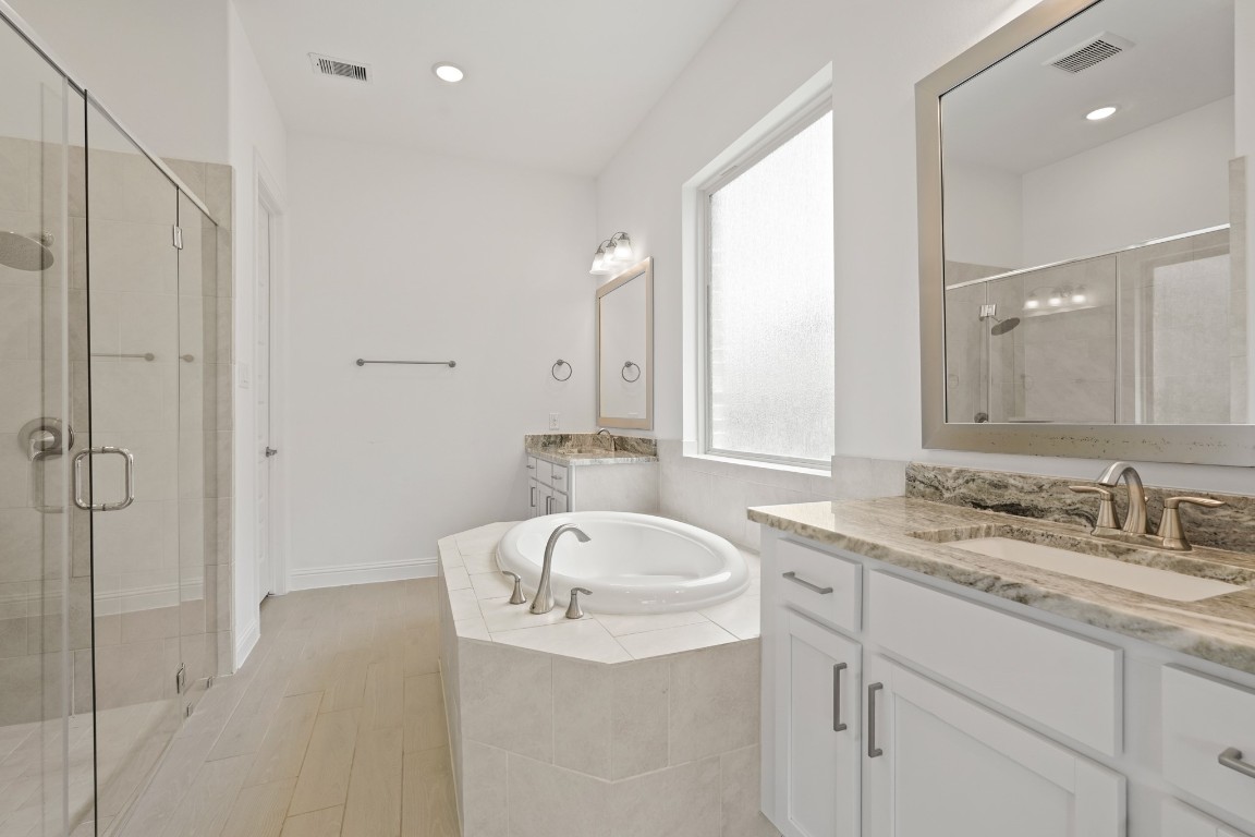 8010 Chantilly Manor Fulshear, TX 77441 - Photo 32 of 50 The primary bathroom features a jetted tub, a stand-up shower, and a dual vanity for added convenience and luxury