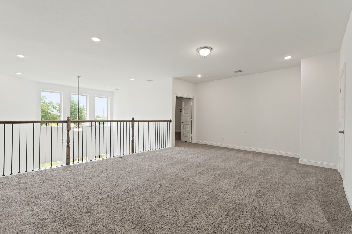 8010 Chantilly Manor Fulshear, TX 77441 - Photo 34 of 50 The game room features an open-to-below design, creating a spacious and connected feel to the living area below