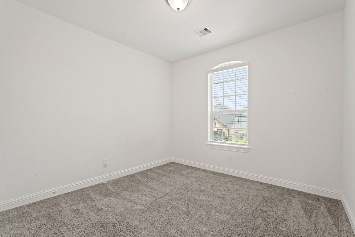 8010 Chantilly Manor Fulshear, TX 77441 - Photo 36 of 50 Cozy third bedroom featuring soft carpeting and abundant natural light.