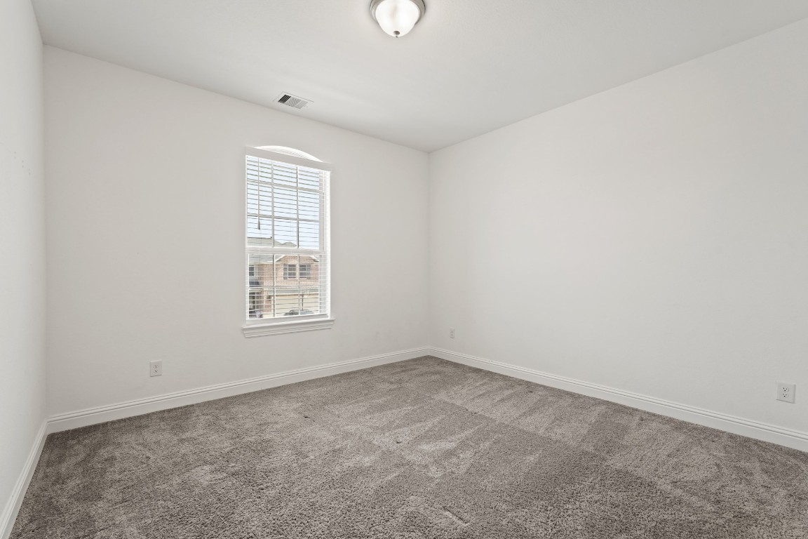 8010 Chantilly Manor Fulshear, TX 77441 - Photo 37 of 50 Cozy and inviting, Bedroom 4 offers ample natural light and plush carpeting, perfect for relaxation.