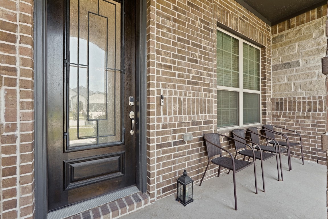 8010 Chantilly Manor Fulshear, TX 77441 - Photo 5 of 50 Sleek front door with a Schlage Encode keyless lock for enhanced security and convenience.