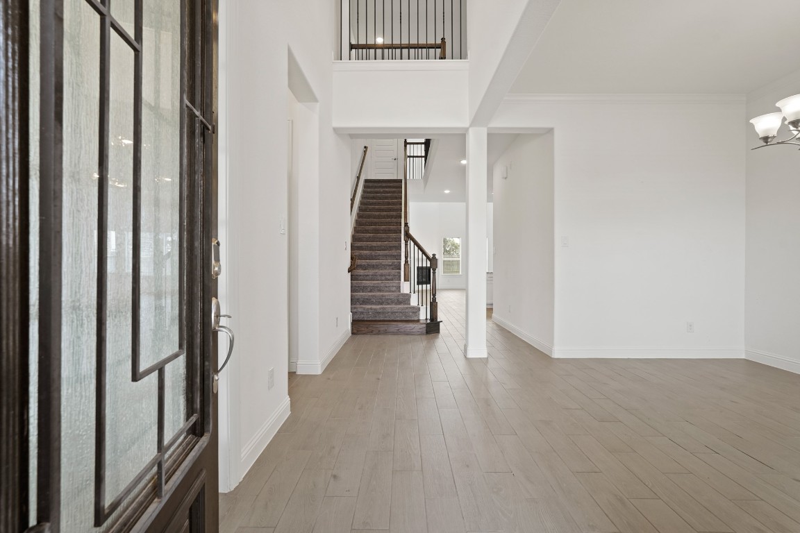 8010 Chantilly Manor Fulshear, TX 77441 - Photo 6 of 50 Discover a grand entrance with soaring ceilings and elegant wood-look tile flooring.