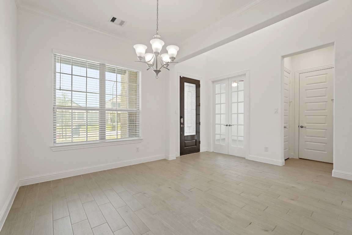 8010 Chantilly Manor Fulshear, TX 77441 - Photo 9 of 50 Explore the elegant formal dining area, adjacent to a versatile office or potential fifth bedroom, with a conveniently located powder room nearby.