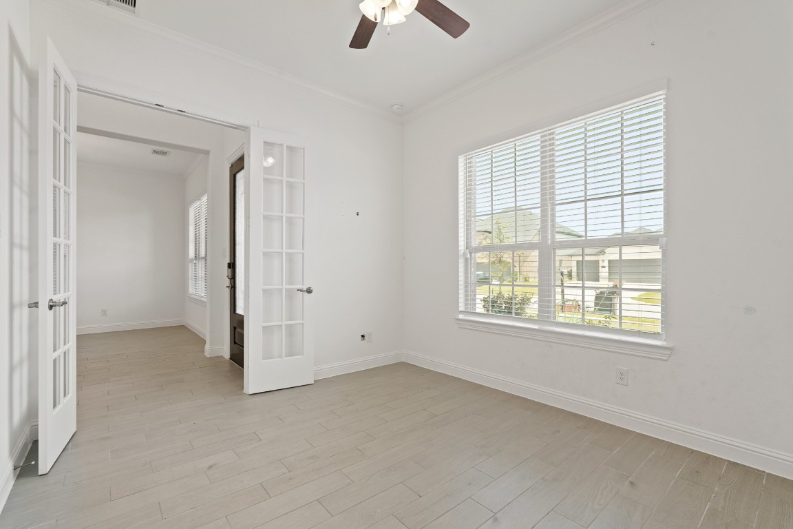 8010 Chantilly Manor Fulshear, TX 77441 - Photo 10 of 50 This versatile first-floor room features elegant French doors and a closet, perfect as an office or a fifth bedroom, adding extra convenience with two bedrooms downstairs.