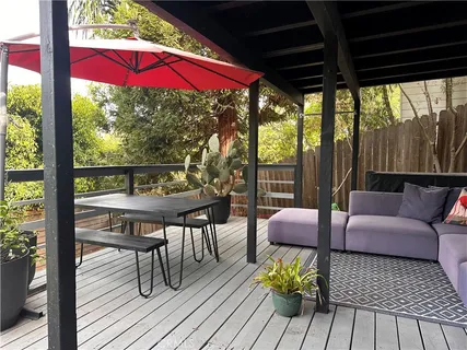 a view of a patio with table and chairs and wooden floor