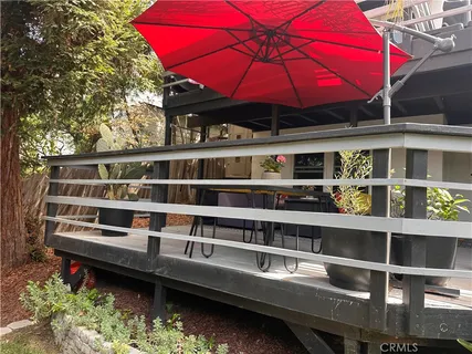 a view of a balcony with a table and chairs under an umbrella