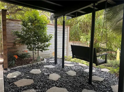a view of a porch with chairs and backyard