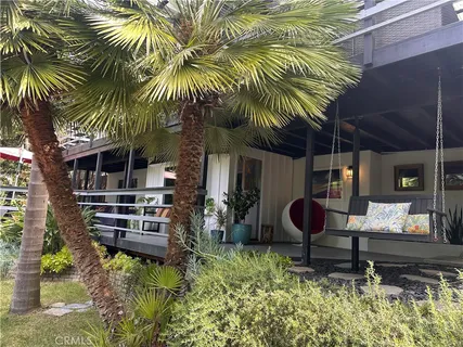 a backyard of a house with barbeque oven table and chairs