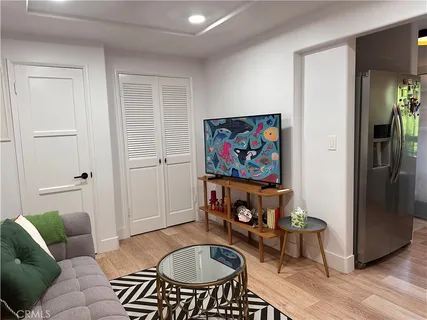 a living room with furniture a rug and a window