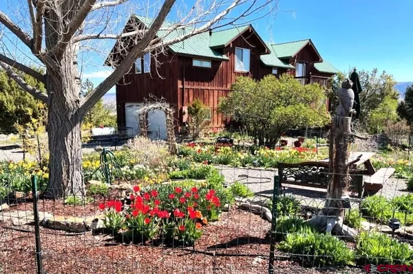 a front view of a house with a yard and fountain