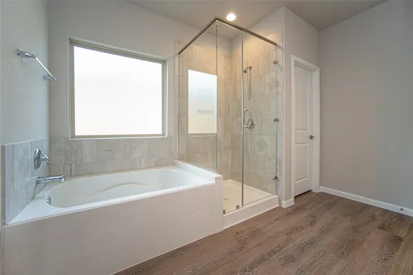 a bathroom with a bathtub and a shower