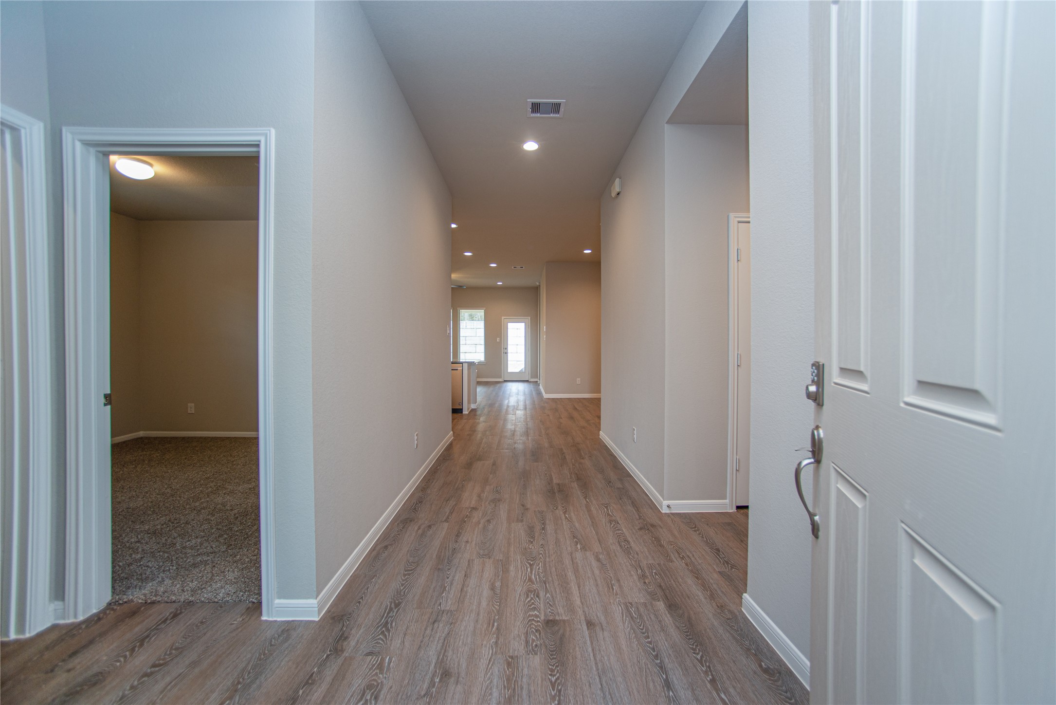 439 Stonebrook Lane Conroe, TX 77304 - Photo 3 of 19 a view of a hallway with wooden floor