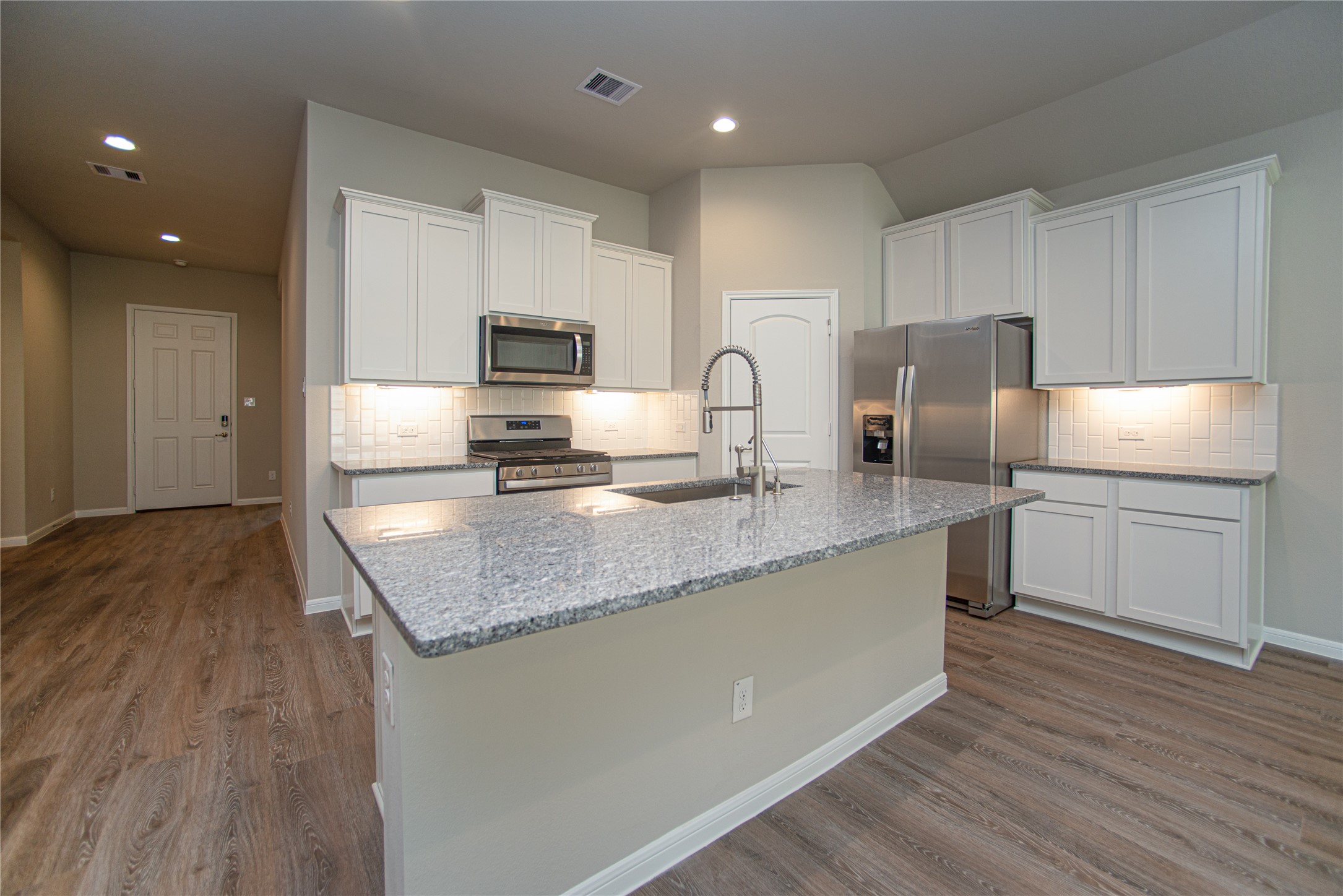 439 Stonebrook Lane Conroe, TX 77304 - Photo 5 of 19 a kitchen with stainless steel appliances granite countertop a sink a stove a refrigerator and cabinets