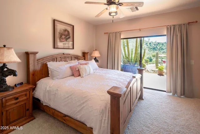 a spacious bedroom with a bed and a window