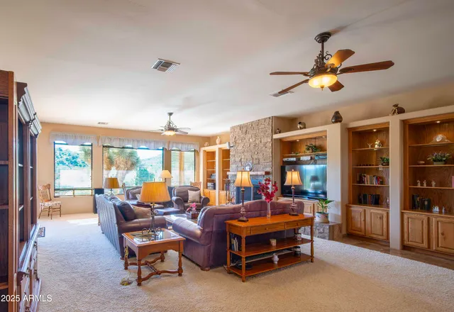 a living room with furniture a chandelier and a large window