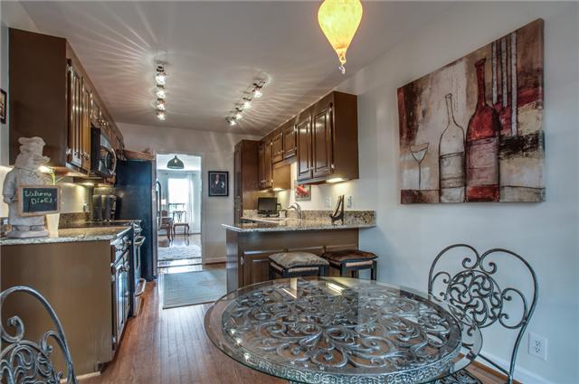 615 Gen George Patton Road Nashville, TN 37221 - Photo 10 of 20 Eat-in kitchen with granite counter tops, stainless steel appliances, hardwood floors, and updated lighting.